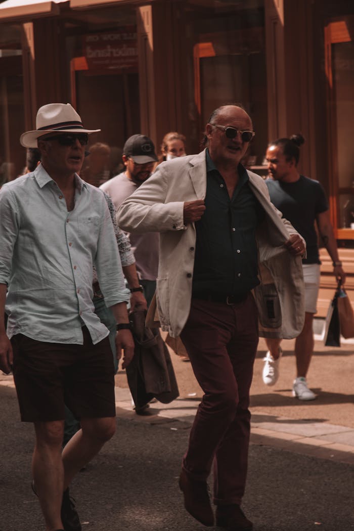 our-services-2 Group of stylish men walking together outdoors on a sunny day.